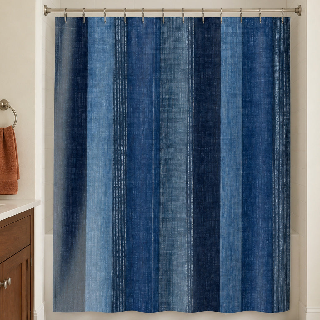 Navy denim stripe shower curtain in a warm white guest bathroom with walnut vanity and clay towel