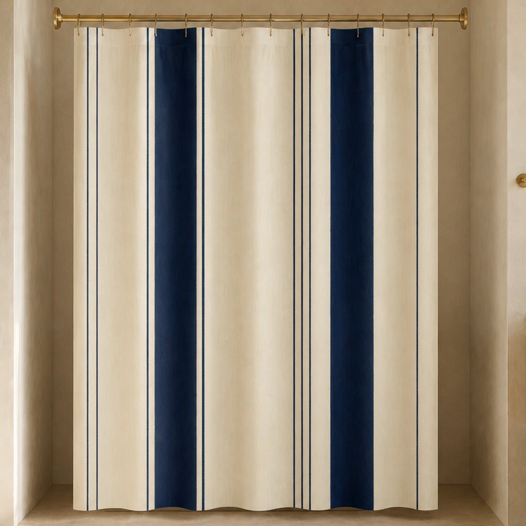 Navy cream pinstripe shower curtain in a luxury bathroom with terracotta stone, mustard cabinetry and brass hardware