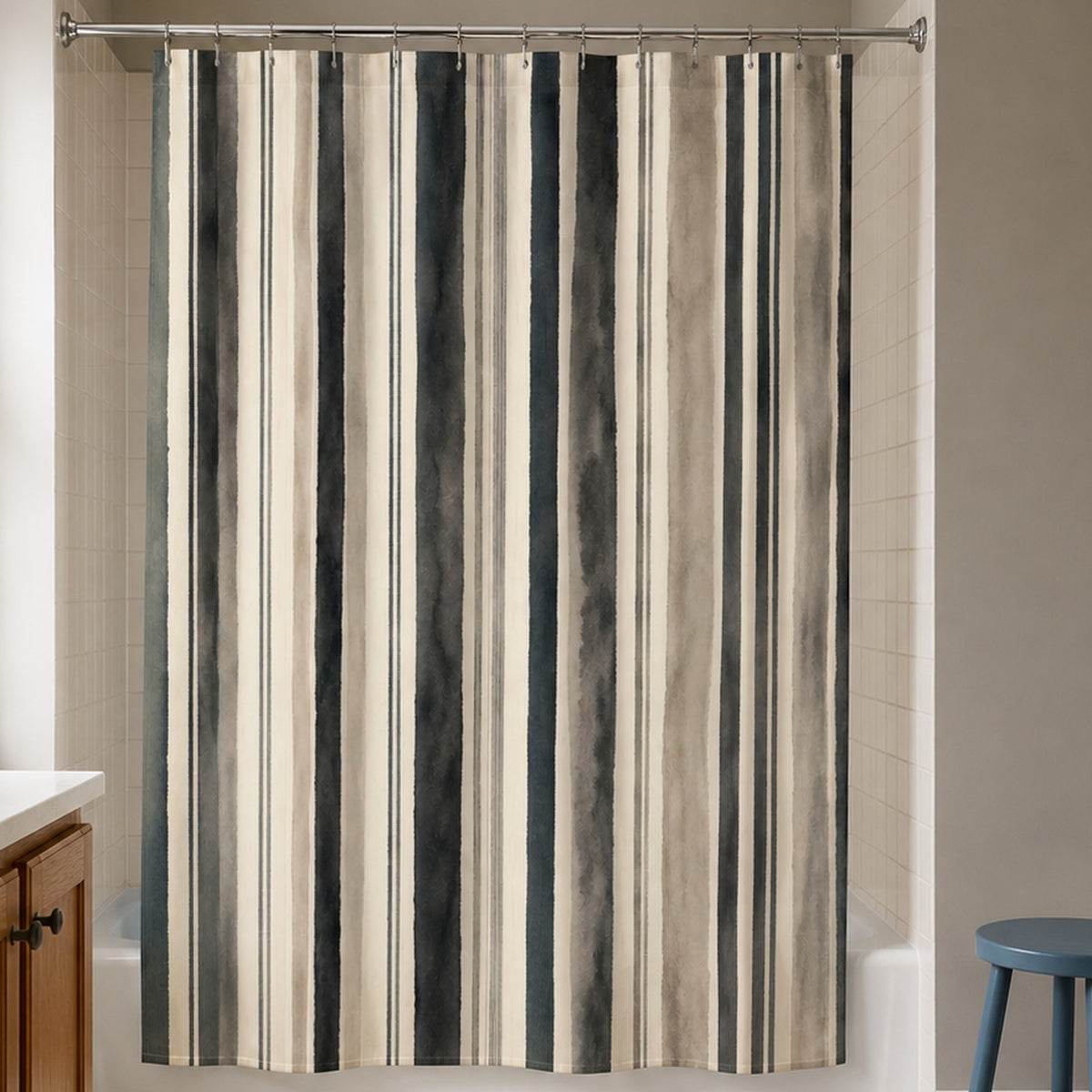 Gray taupe watercolor stripe shower curtain in a warm clay gray bathroom with oak vanity and blue stool