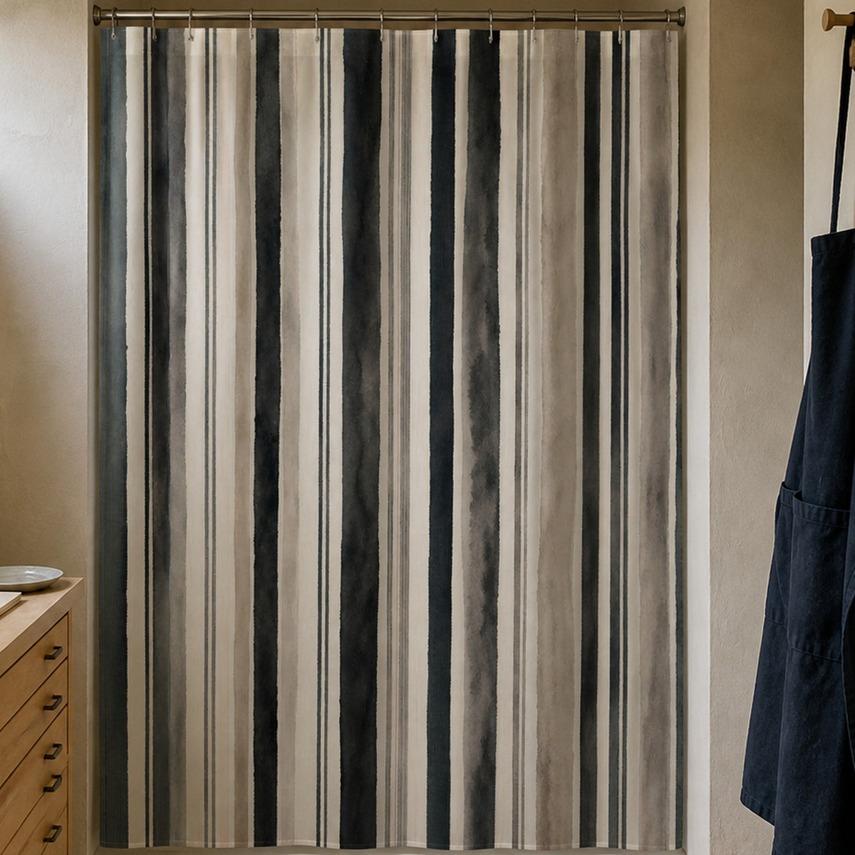 Gray taupe watercolor stripe shower curtain in a paper conservator studio washroom with maple drawers