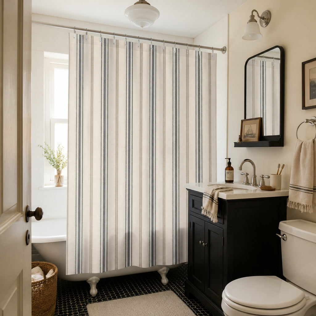 Charcoal and ivory ticking stripe shower curtain in a warm vintage apartment bathroom with a black vanity