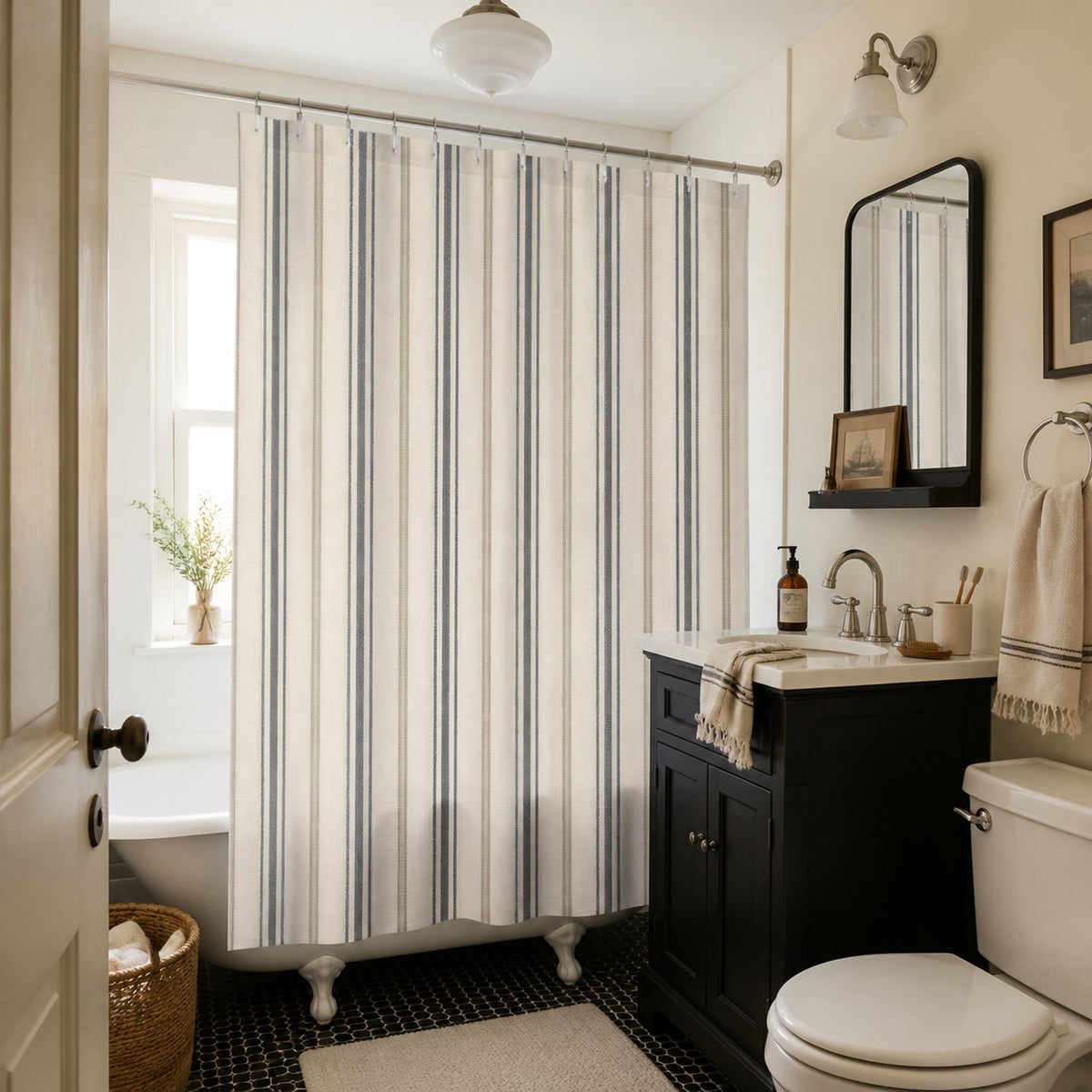 Charcoal and ivory ticking stripe shower curtain in a warm vintage apartment bathroom with a black vanity