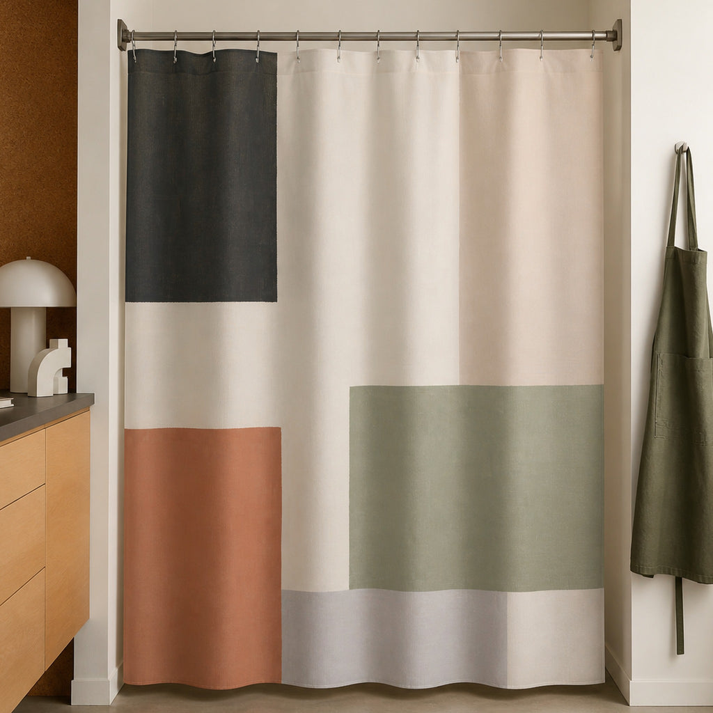 Sage terracotta color block shower curtain in a modernist architect studio washroom with cork and maple