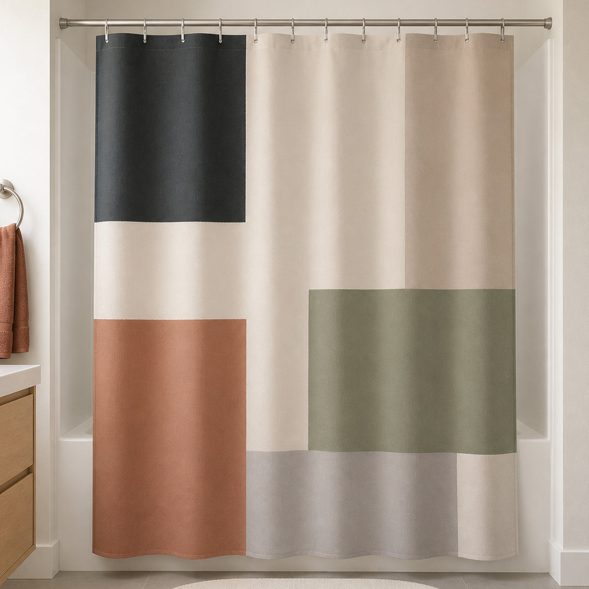 Sage terracotta color block shower curtain in a warm white everyday bathroom with pale oak vanity
