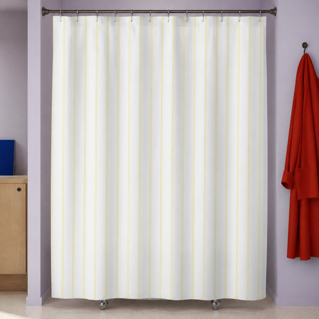 Pale yellow pinstripe shower curtain in a lilac modernist bathroom with vermilion robe and cobalt folio
