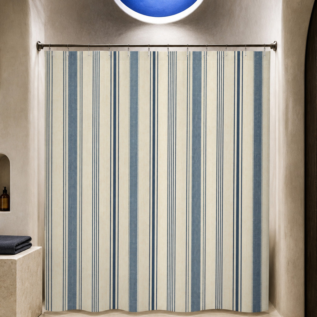 Indigo ivory ticking stripe shower curtain in a luxury lime plaster bathroom with cobalt oculus and pale limestone