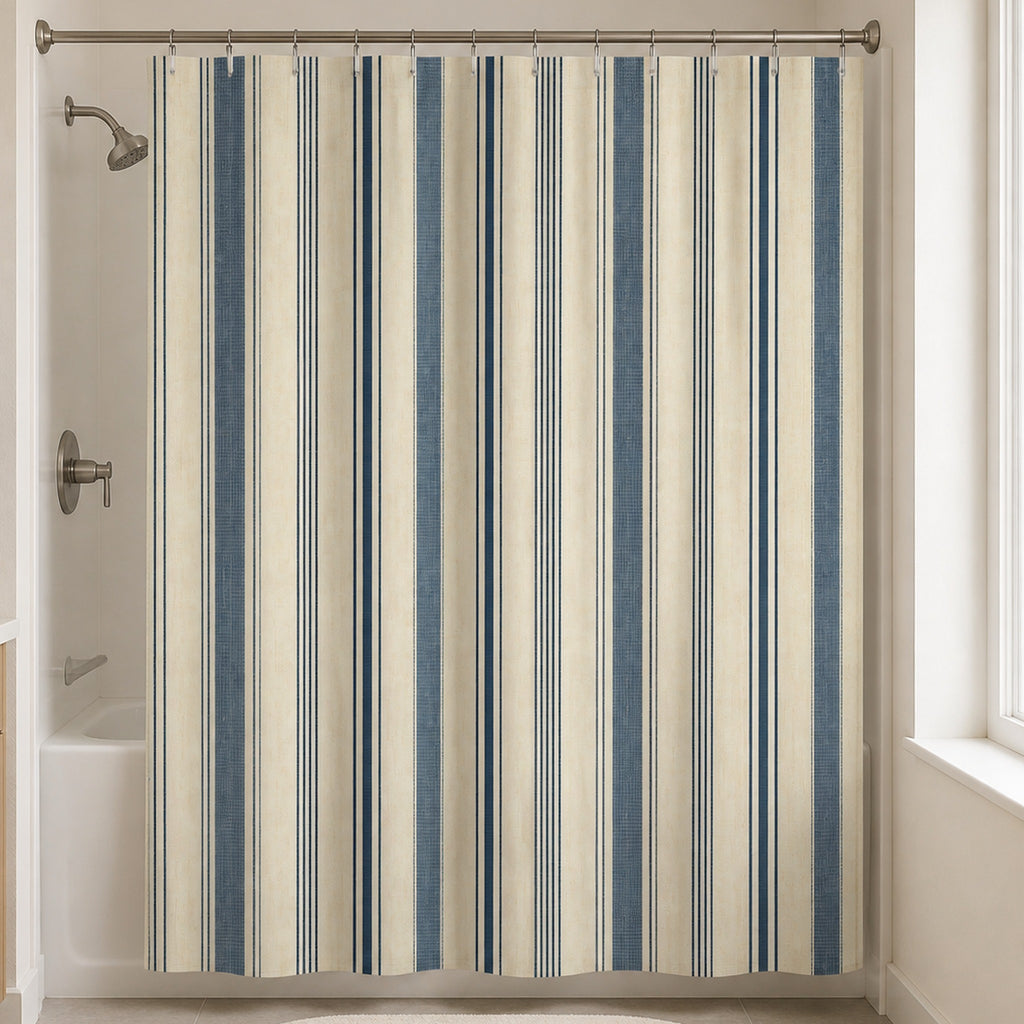 Indigo ivory ticking stripe shower curtain in an attainable warm white bathroom with pale oak vanity and slate blue towel